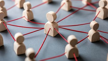 wooden people figurines connected by red string