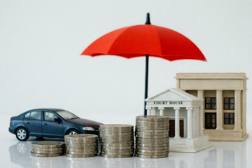 car, government buildings and coins underneath an umbrella