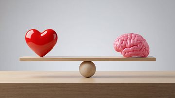 a heart and brain sit on opposite sides of a scale